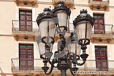 Vintage metal lantern on background typical building facade with balconies in Tarragona, Spain Stock Photo