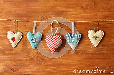 Five hearts made of cloth on wood background Stock Photo