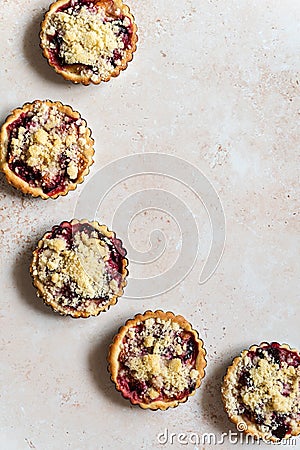 Five home baked plum crumble tarts from above Stock Photo