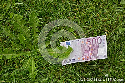 Five hundred 500 Euro banknote money bill on fresh green grass Stock Photo