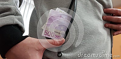 Five hundred euro bills in a pocket of white man Stock Photo