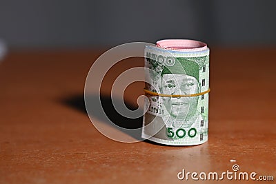Five hundred Naira note rolled amidst other Naira Stock Photo