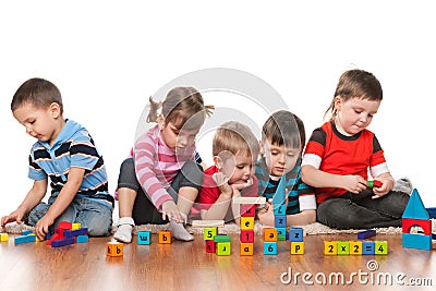 Five kids playing on the floor Stock Photo