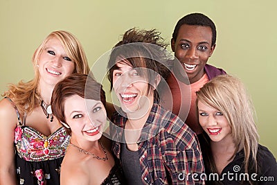 Five laughing urban teens in front of green wall Stock Photo