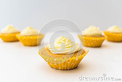 Five frosted cupcakes against a white light background Stock Photo