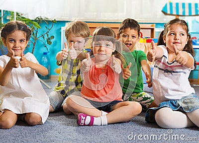 Five little children with thumbs up Stock Photo