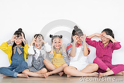 Five little girls raising their hands Stock Photo