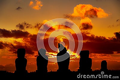 Five moais at Easter Island against orange and red sunset Stock Photo