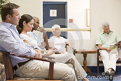 Five people waiting in waiting room Stock Photo