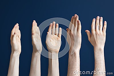 the five raised human hands isolated on the colourful background as a concept of vote and agree Stock Photo