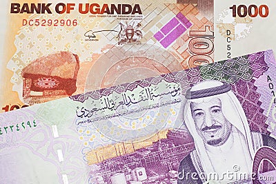 Ugandan currency paired with money from Saudi Arabia Stock Photo