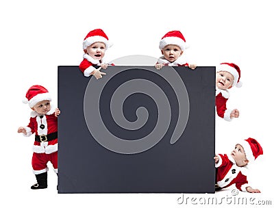 Five Santa Claus baby hold black advertisment banner blank Stock Photo