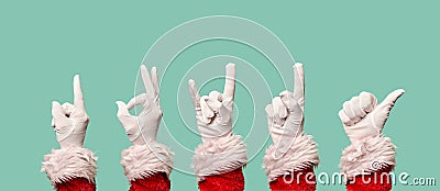 Five Santa's hands in white gloves on blank blue background. Stock Photo