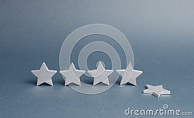 Five silver stars, one star fell. Loss of rating and level, reducing prestige and reputation. Rating and status of the restaurant Stock Photo