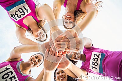 Five smiling runners supporting breast cancer marathon Stock Photo