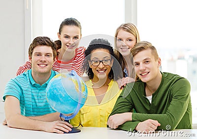 Five smiling student with earth globe at school Stock Photo