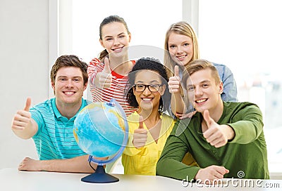 Five smiling student with earth globe at school Stock Photo