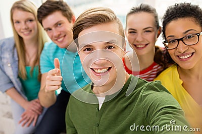 Five smiling students taking selfie at school Stock Photo