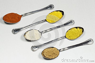Five spoons containing different types of spices powder Stock Photo