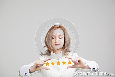 Five star rating or ranking, benchmarking concept. Woman assesses service, hotel, restaurant Stock Photo