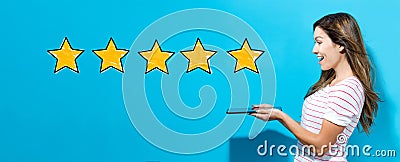 Five star rating with woman using a tablet Stock Photo