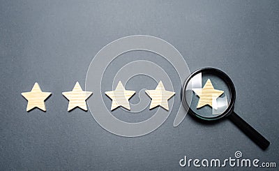 Five stars and a magnifying glass on the last star. Check the credibility of the rating or status of the institution, hotel Stock Photo