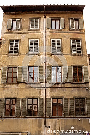 Five storey apartment building with shutters on the windows Editorial Stock Photo