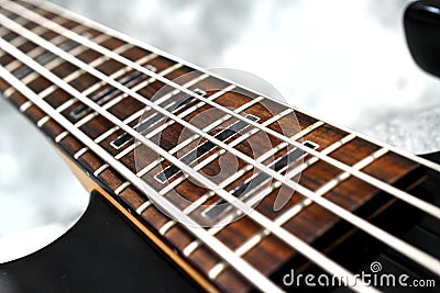 Five string bass guitar frets fretboard and strings Stock Photo