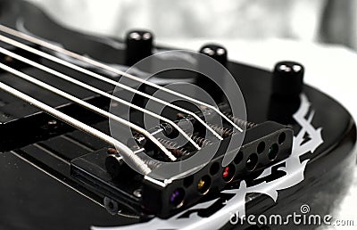 Five string bass guitar frets fretboard and strings volume and tone knobs Stock Photo