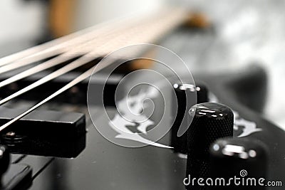 Five string bass guitar frets fretboard and strings volume and tone knobs Stock Photo