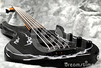 Five string bass guitar frets fretboard and strings volume and tone knobs tribal decal Stock Photo