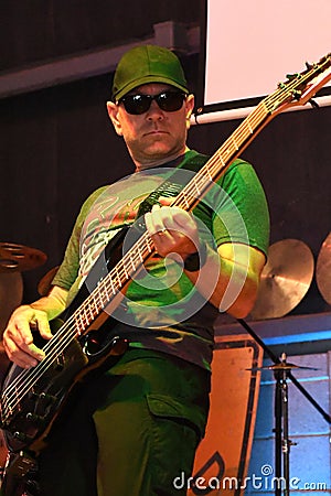 Five string bass guitar player at live rock concert Stock Photo