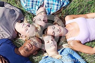 Five students relaxing outside Stock Photo