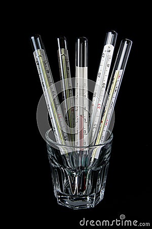 Five thermometers in the glass Stock Photo