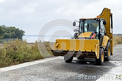Five-Ton Wheel Loader Bulldozer, Tractor With Bucket working Editorial Stock Photo
