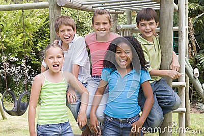 Five young friends at a playground smiling Stock Photo