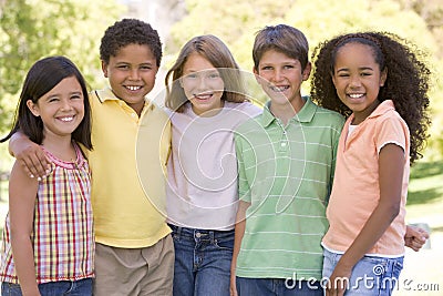 Five young friends standing outdoors smiling Stock Photo