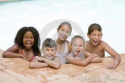 Five young friends in swimming pool smiling Stock Photo