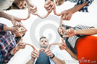 Five young smiling people make star shape from fingers Stock Photo