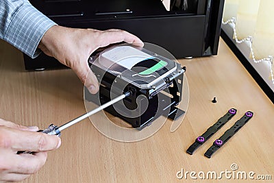 Fix screw hard disks memory in fixing basket when installing in computer Stock Photo