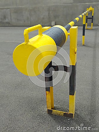 Yellow and black Roadblock Road Barrier perspective view. Metal security barrier. Fixed gate barrier. Beaconing and signaling Stock Photo