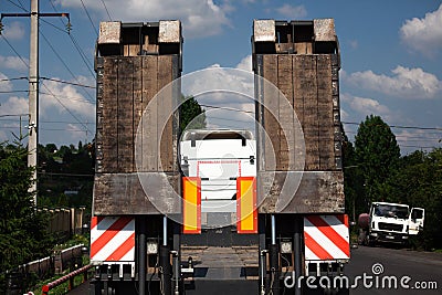 Fixed low loader trawl. Truck carries special equipment. Low loader trawl on the road. Freight transport. road machinery Stock Photo