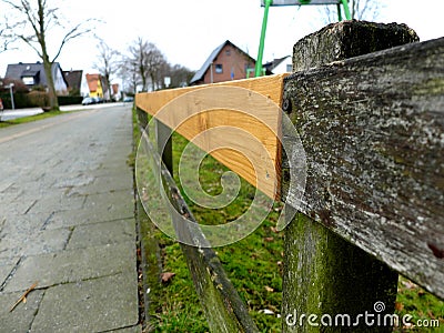 Fixed wooden fence. The concept of something old being fixed, patched or upgraded Stock Photo
