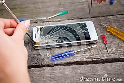 Fixing damaged smartphone Stock Photo
