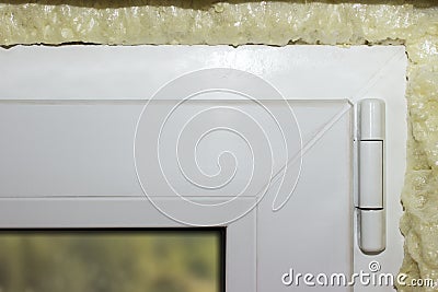 Fixing a window using polyurethane foam. Installing polyurethane foam around the window Stock Photo