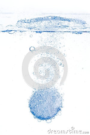 Fizzy tablet dissolving in water Stock Photo