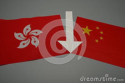 A flag of Hong Kong and one of China, with a white arrow, which separates Stock Photo