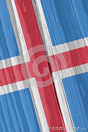The flag of Iceland on a dry wooden surface, cracked with age. Light pale faded paint. Patriotic background or wallpaper. Stock Photo