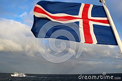 Flag of Iceland Flies Over Ocean Stock Photo