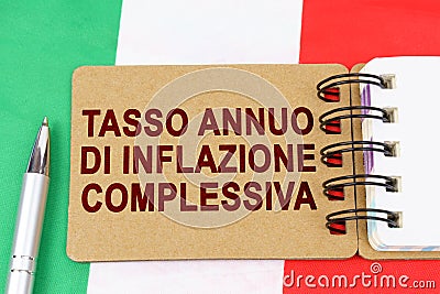 On the flag of Italy lies a pen and a notebook with the inscription - Annual headline inflation rate Stock Photo